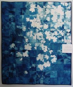 a blue and white painting with leaves on it