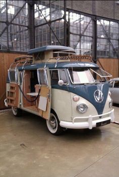 an old vw bus is parked in a garage