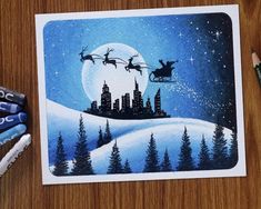 a drawing of santa's sleigh flying over a city at night with the moon in the sky