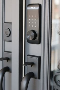 an electronic door lock is shown on the outside of a building's front door