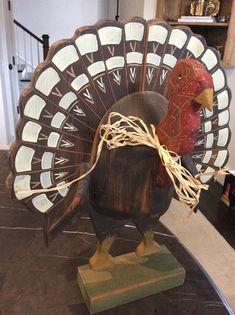 a wooden turkey on display in a room