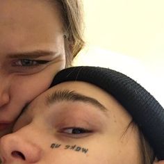 two people with their faces close to each other and the words wake up written on their foreheads