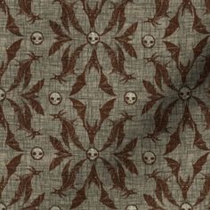 a fabric with skulls on it and leaves in the middle, as well as an image of