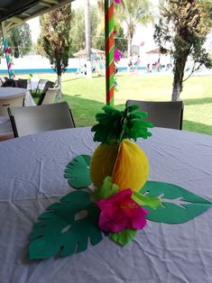 a table with paper flowers on it at an outdoor event in the park or resort