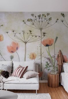 a living room with flowers painted on the wall