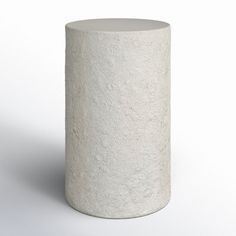 a white round concrete object on a white background with no one around it to see