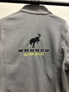 the back of a gray jacket that says bronco outer banks