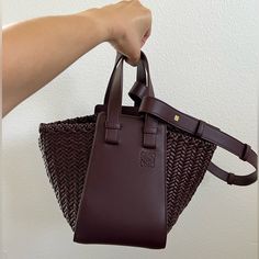 This Stunning, Authentic Loewe Compact Hammock Bag In Luxurious Calfskin Is An Elegant Mix Of Style And Functionality. Handcrafted In Spain With Meticulous Attention To Detail, The Bag’s Unique Shape And Premium Materials Make It A Versatile Bag That Can Be Carried In Multiple Ways. Color: Dark Burgundy Height: 8.2 Inches Width: 5.7 Inches Depth: 7.7 Inches Made In Spain Loewe Hammock Bag, Loewe Bag, Hammock, Mini Bag, Calf Skin, Bag Lady, Brand New, Color