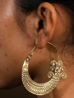 "Add a touch of unique ethnic style with our brass Hmong earrings. These hoops are perfect for anyone looking to add a playful twist to their wardrobe. (Excuse the pun, but these earrings are H'mong-stly the best!)" Traditional Single Brass Earring, Ornate Handmade Brass Hoop Earrings, Festive Brass Hoop Earrings With Intricate Design, Ornate Brass Earrings For Festival, Ornate Brass Festival Earrings, Brass Chandbali Hoop Earrings, Ornate Chandbali Earrings For Festival, Traditional Festival Plug Earrings, Traditional Pierced Plug Earrings For Festivals