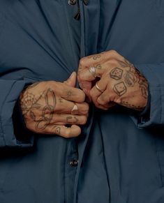 a man with tattoos on his arms and hands