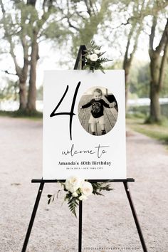 a sign that is on top of a easel with flowers in it and the number forty