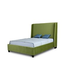 a green bed with blue pillows on it