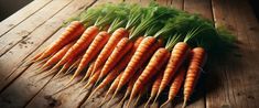 a bunch of carrots sitting on top of a wooden table next to each other