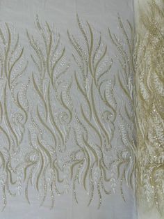 an embroidered table cloth with silver sequins on it