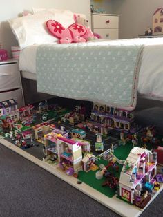 an image of a bed with lots of toys on top of it in the room