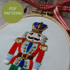 an embroidery pattern with a nutcracker wearing a crown