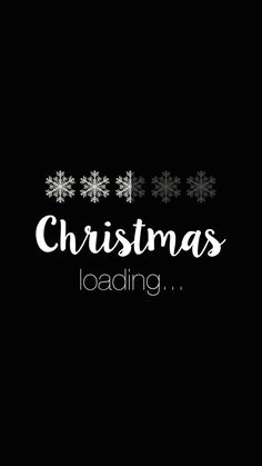 a black background with white snowflakes and the words christmas loading on it's side