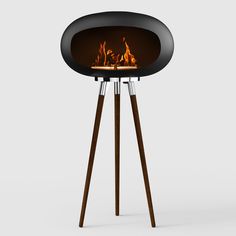 a black and wood stand with a fire in the center on it's legs