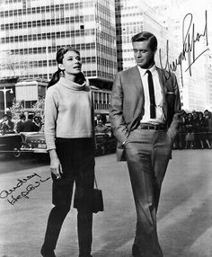 black and white photograph of man and woman walking down the street