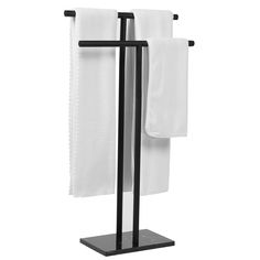 two white towels are hanging on a black stand