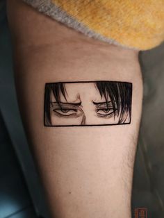 a man's leg with an anime avatar tattoo on it