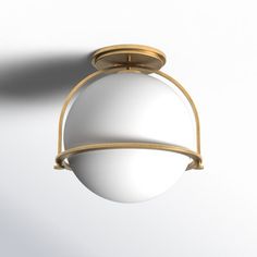 a white ball hanging from the ceiling with a gold ring around it's edge