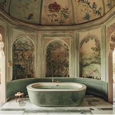 a bathtub in the middle of a room with paintings on the walls and ceiling