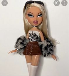 the doll is wearing a skirt and boots with fur on it's back legs