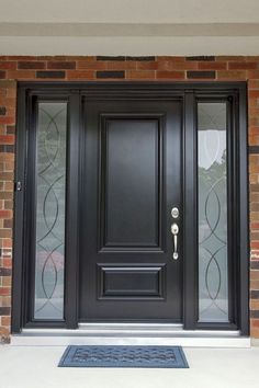 a black front door with glass panels on the side