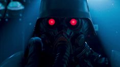 a man in a gas mask with red lights on his face and hands behind him