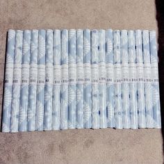 a stack of blue and white candles sitting on top of a carpeted floor next to each other