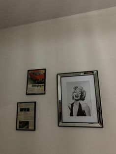 three framed photographs hang on the wall next to each other