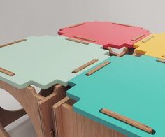 four different colored tables with wooden handles on each side and one has a square shaped table top