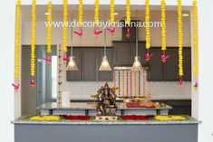 the kitchen is decorated with yellow flowers and garlands hanging from the ceiling over the island