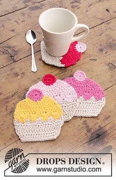 two crocheted coasters with cupcake designs and a spoon on the side