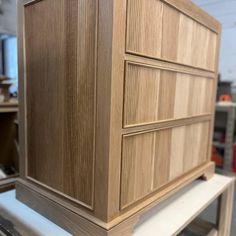 a wooden cabinet sitting on top of a table