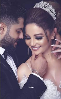 a bride and groom pose for a wedding photo in front of a black background with the words dream written on it