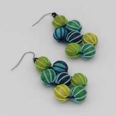 Add a touch of sophistication and art to your ensemble with our Green Pamela Berries Earrings. These statement earrings feature intricately wrapped beads in a gorgeous blend of green and blue, hanging elegantly from a french wire. Elevate your look with these artistic dangle earrings. Earrings hang 2.5" in length Care Instructions: Remove jewelry when applying perfumes, creams, washing hands etc. Do not store in direct sunlight. to restore color and shine apply a drop of oil with a soft cloth Unique Green Earrings With Colorful Beads, Handmade Adjustable Green Wrap Earrings, Adjustable Handmade Green Wrap Earrings, Green Drop Earrings With Colorful Beads, Handmade Turquoise Fusion Earrings, Blue Fusion Drop Earrings, Blue Fusion Earrings For Pierced Ears, Unique Green Round Beads Earrings, Blue Fusion Style Drop Earrings