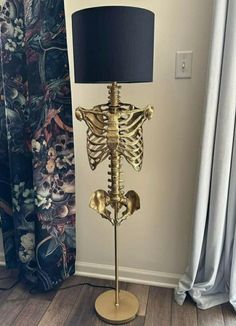 a skeleton lamp with a black shade on it