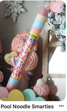 there is a large candy stick in the middle of many other candies and decorations