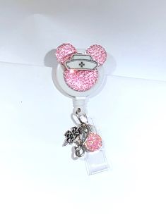 a minnie mouse key chain with pink glitter