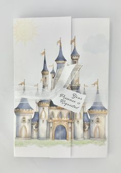 an open book with a watercolor drawing of a castle on it's cover