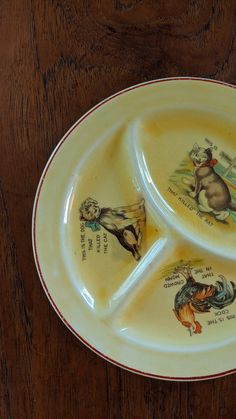 two plates with animals painted on them sitting on a table