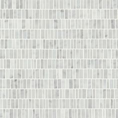 a white and grey tile wall with squares