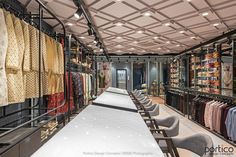 the inside of a clothing store with rows of tables and chairs