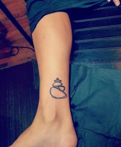 a woman's foot with a teapot tattoo on it