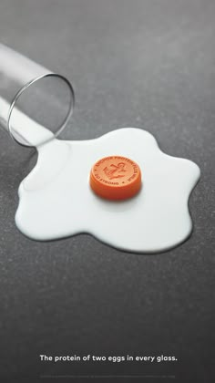 an orange button sitting on top of a white plate