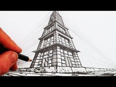 a drawing of the eiffel tower in black and white with a person's hand holding a pen