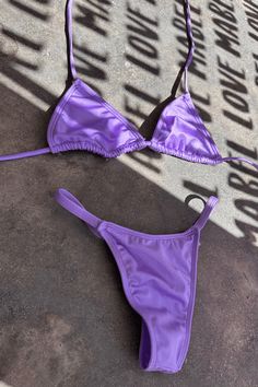 Introducing our stunning Unicorn lavendar 2 Piece T String Bikini! This eye-catching swimsuit is beautifull in the sunlight. The bikini top features a flattering halter neckline and adjustable straps for a comfortable and secure fit. The matching bottom offers moderate coverage with a scrunch bottom. Perfect for the fashion-forward beach-goer, this Unicorn 2 Piece Bikini is sure to turn heads and make a statement. Get ready to shine this summer with this must-have swimsuit! This Unicorn Lavender Purple Triangle Top Swimwear For Beachwear, Purple Halter Neck Swimwear For Summer, Summer Halter Neck Purple Swimwear, Summer Lavender Swimwear For Swimming, Purple Halter Neck Swimwear For Beach Party, Purple Halter Neck Swimwear For Pool, Purple Halter Neck Swimwear For Beach, Poolside Purple Halter Neck Swimwear, Summer Purple Swimwear For Sunbathing