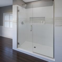 an empty bathroom with a glass shower door